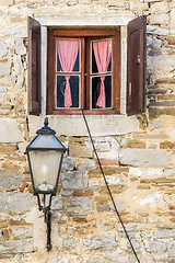 Image showing nice window with open brown  wooden shutters and curtains