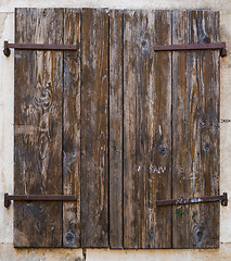 Image showing old window with  closed wooden shutters