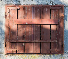 Image showing old window with  closed wooden shutters