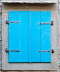 Image showing old window with  closed blue wooden shutters
