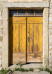 Image showing yellow ragged shabby wooden door