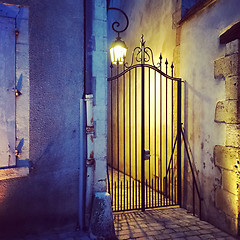 Image showing Iron gate and streetlight