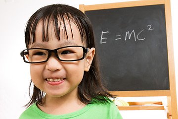 Image showing Asian Chinese little girl againts blackboard with formulas