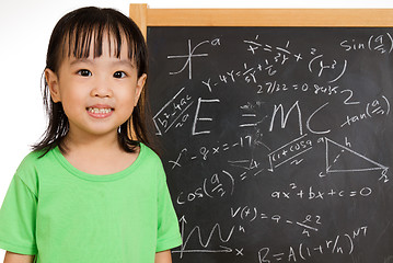 Image showing Asian Chinese little girl againts blackboard with formulas