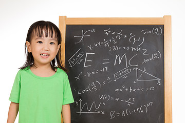 Image showing Asian Chinese little girl againts blackboard with formulas