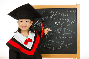 Image showing Asian Chinese little girl in graduation gown againts blackboard 