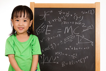 Image showing Asian Chinese little girl againts blackboard with formulas