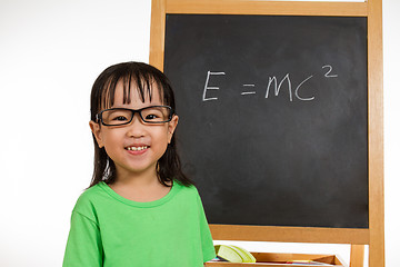 Image showing Asian Chinese little girl againts blackboard with formulas