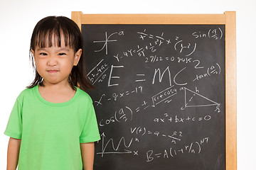 Image showing Asian Chinese little girl againts blackboard with formulas