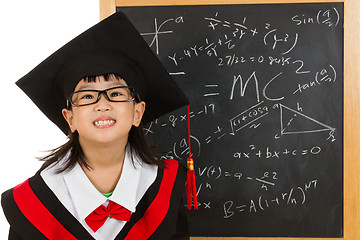 Image showing Asian Chinese little girl in graduation gown againts blackboard 