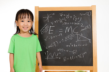 Image showing Asian Chinese little girl againts blackboard with formulas