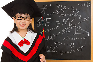 Image showing Asian Chinese little girl in graduation gown againts blackboard 