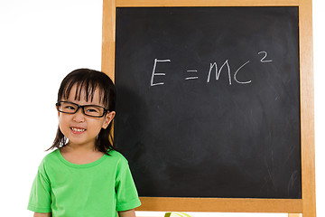 Image showing Asian Chinese little girl againts blackboard with formulas