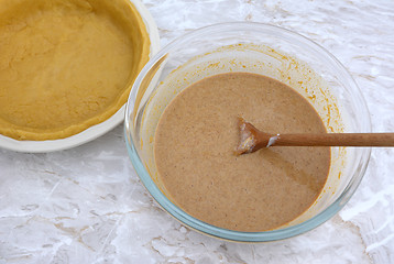 Image showing Pumpkin pie filling with an empty pie shell