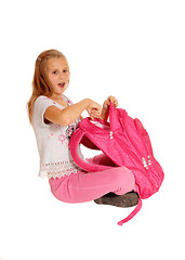 Image showing Surprised girl pointing on backpack.