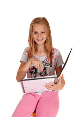 Image showing Schoolgirl pointing at her book.