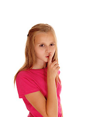 Image showing Pretty blond girl with finger over mouth.