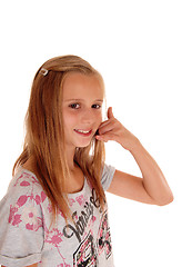 Image showing Young girl gesturing a phone call.