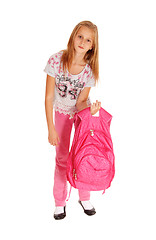 Image showing Schoolgirl lifting heavy backpack.