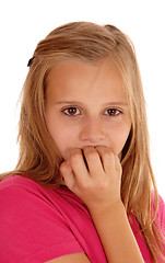 Image showing Young girl biting her fingernails.