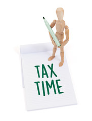 Image showing Wooden mannequin writing - Tax time