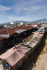 Image showing roof of poor houses by the river