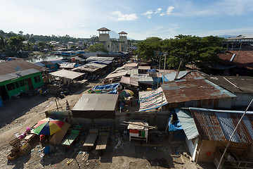 Image showing Straw poor houses by the river