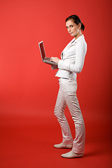 Image showing Female with Computer on Red