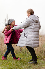 Image showing Sisters having fun in colorful autumn day