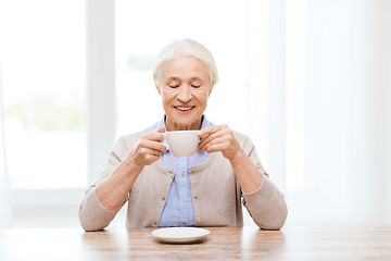 Image showing happy senior woman with cup of coffee