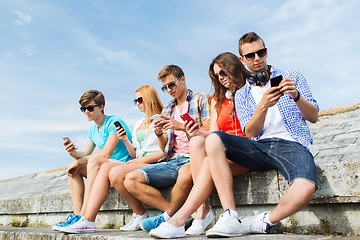 Image showing group of friends with smartphone outdoors