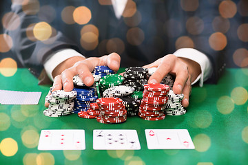 Image showing poker player with cards and chips at casino