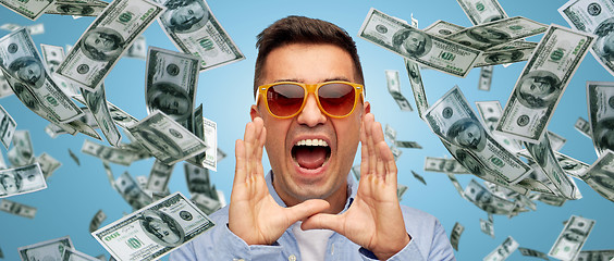 Image showing face of shouting man with falling dollar money