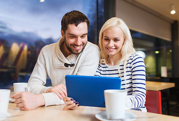 Image showing happy couple with tablet pc and coffee at cafe