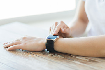 Image showing close up of hands setting smart watch