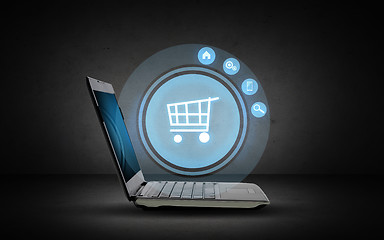 Image showing laptop computer with shopping cart icon projection