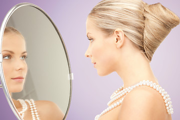 Image showing beautiful woman with pearl necklace and mirror