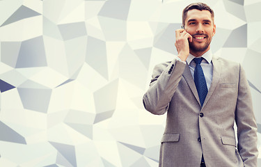 Image showing smiling businessman with smartphone outdoors