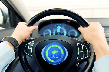 Image showing close up of young man driving car in eco mode