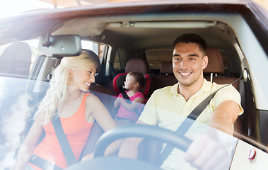 Image showing happy family with little child driving in car