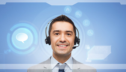 Image showing smiling businessman in headset over virtual screen