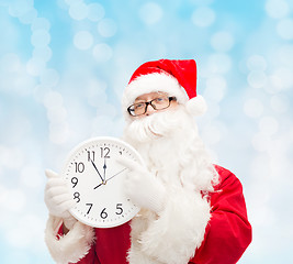 Image showing man in costume of santa claus with clock