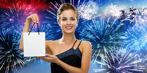 Image showing smiling woman with white blank shopping bag