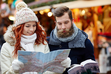 Image showing happy couple with map and city guide in old town
