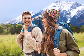 Image showing smiling couple with backpacks hiking