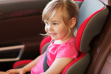 Image showing happy little girl sitting in baby car seat