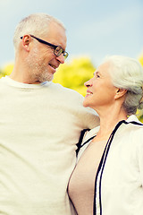 Image showing senior couple hugging in city park