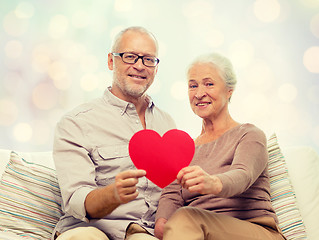 Image showing happy senior couple with red heart shape