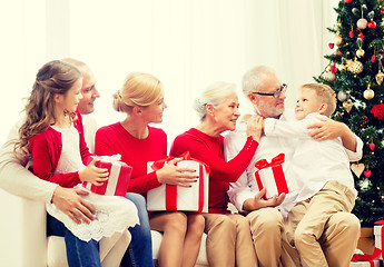 Image showing smiling family with gifts at home