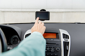 Image showing close up of man with gps navigator driving car